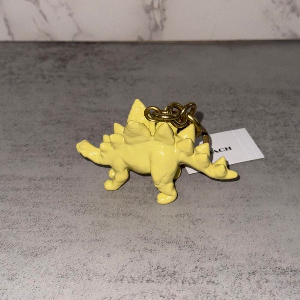 Coach yellow stegosaurus keychain
